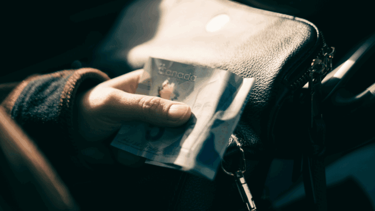 Canadian Holding a 5 dollar bill